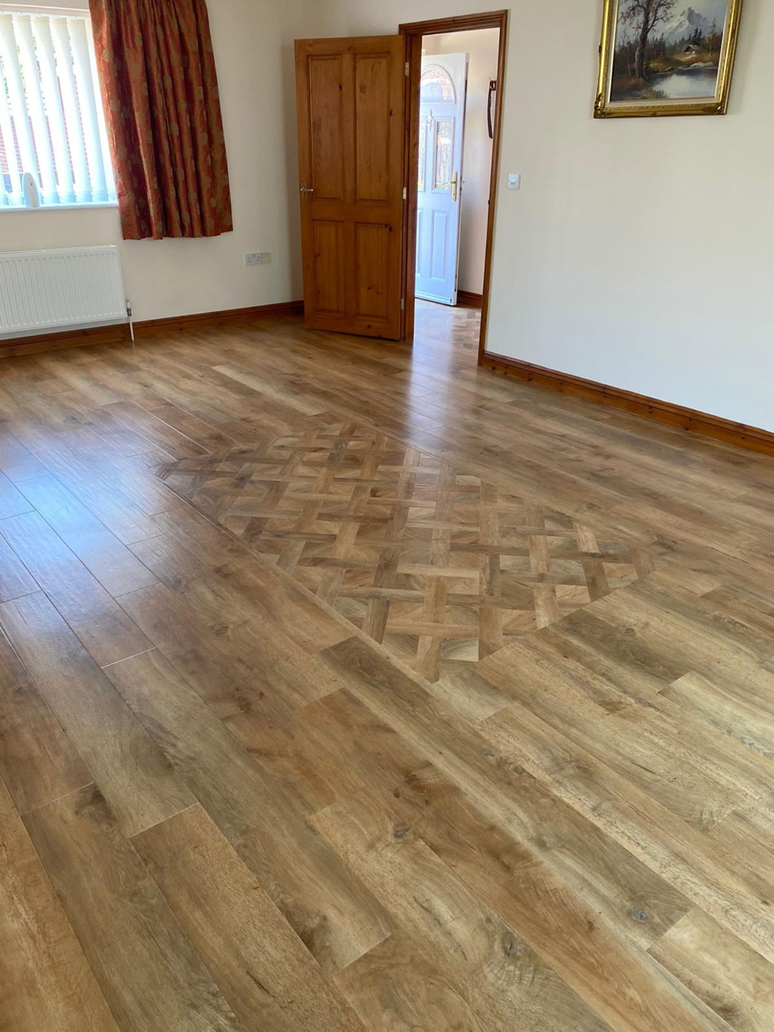 Empty room with Karndean - Art Select - Spring Oak plank with a inlaid rug of Karndean Art Select - Spring Oak Basket Weave. On the floor